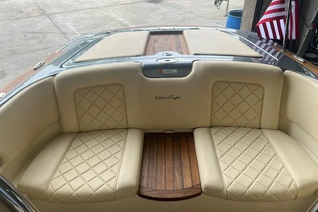 Slide: The Image of 2019 Chris-Craft Launch 23 boat interior with beige quilted seats and wooden accents. - 10