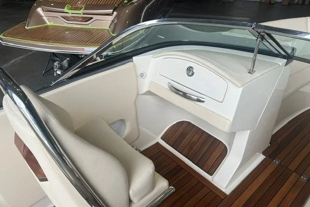 Slide: The Image of 2019 Chris-Craft Launch 23 boat interior with elegant wood flooring and sleek dashboard design. - 14