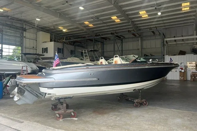Slide: The Image of 2019 Chris-Craft Launch 23 boat in a spacious indoor storage facility. - 2