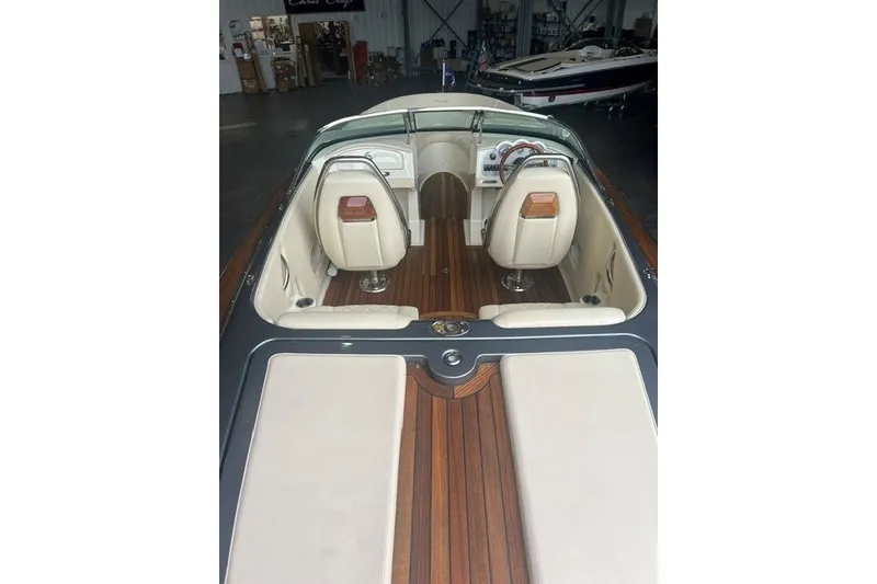 Slide: The Image of 2019 Chris-Craft Launch 23 boat interior with elegant wood and leather seating. - 12