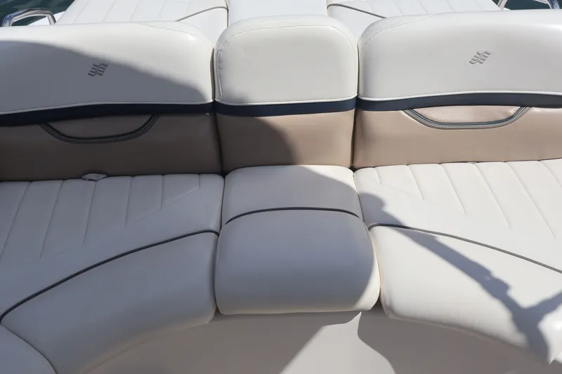 Slide: The Image of 2006 Four Winns H240 boat interior with beige and white cushioned seating. - 22