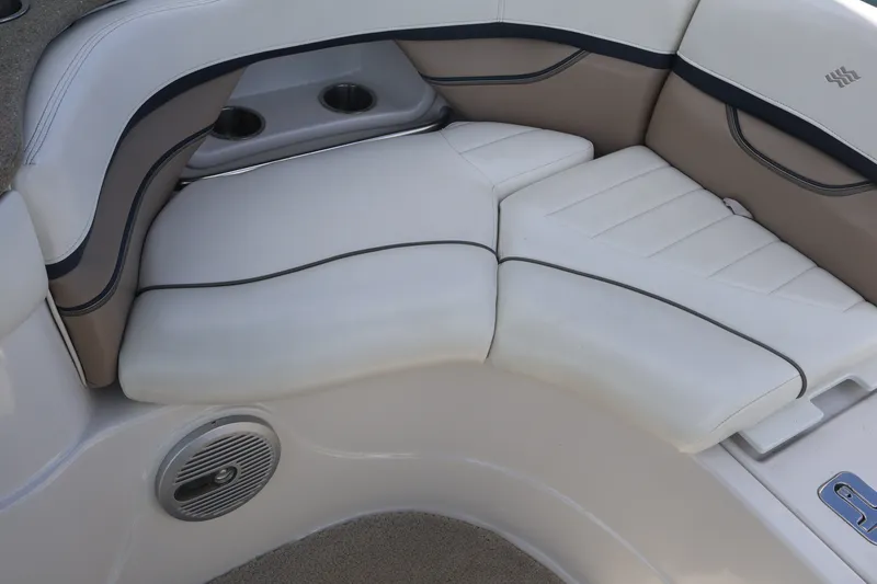 Slide: The Image of 2006 Four Winns H240 boat interior seating with cup holders and speaker. - 23