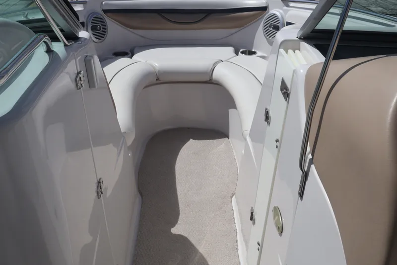 Slide: The Image of Interior of 2006 Four Winns H240 boat with beige seating and carpeted floor. - 40