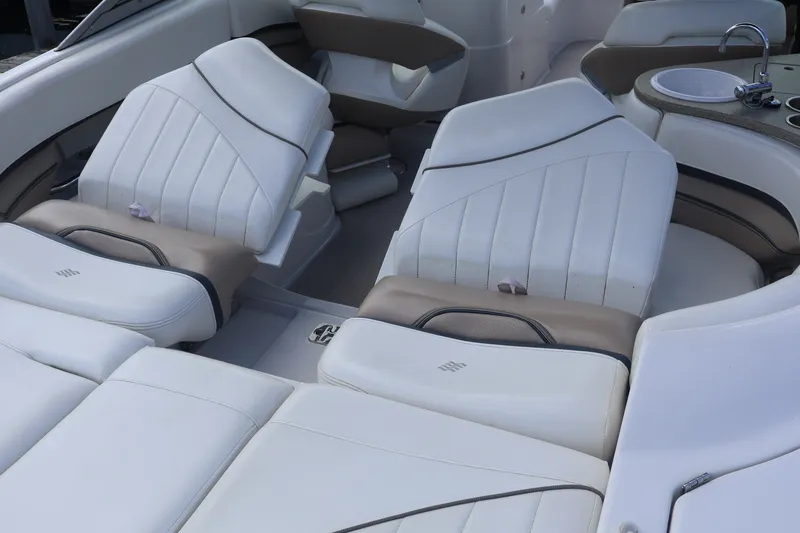 Slide: The Image of Luxurious interior of 2006 Four Winns H240 boat with white leather seating. - 16
