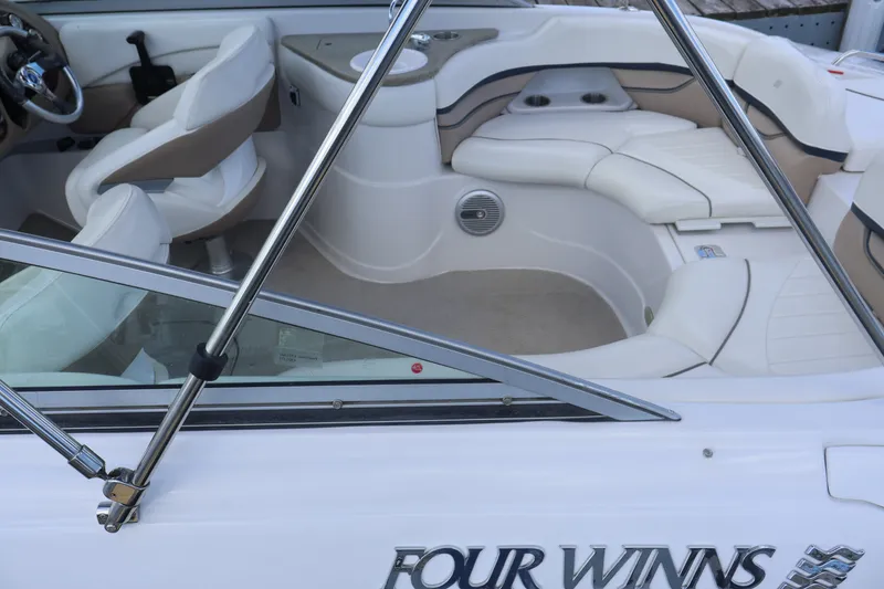 Slide: The Image of Interior of 2006 Four Winns H240 boat with white seating and steering wheel. - 20