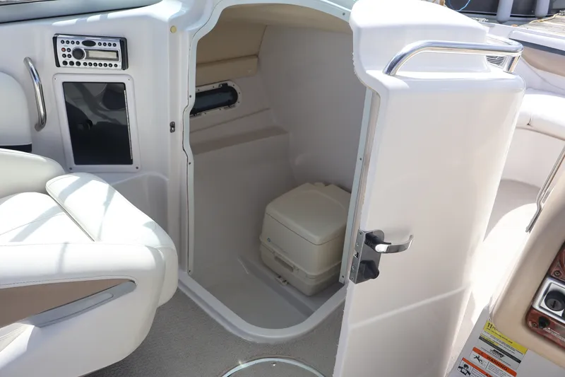 Slide: The Image of Interior of 2006 Four Winns H240 boat showing compact restroom with toilet. - 31