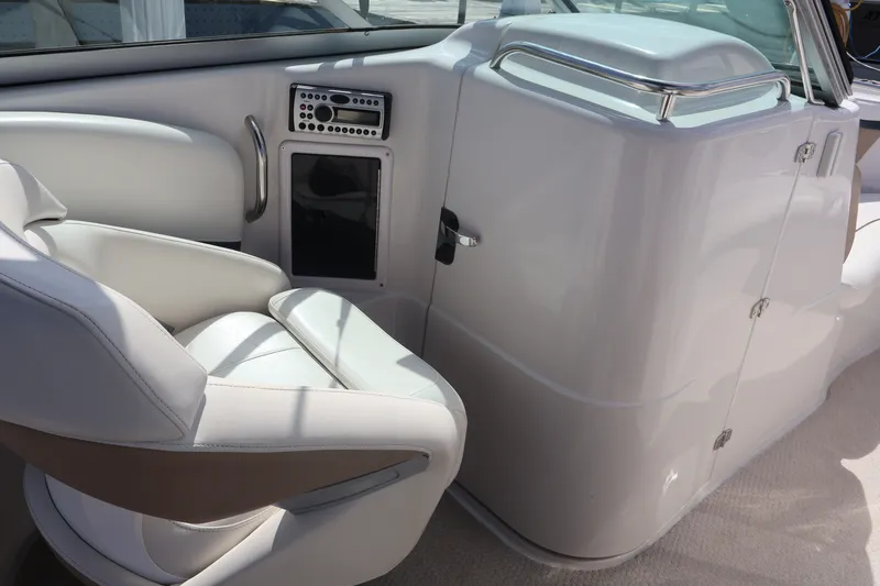 Slide: The Image of Interior of 2006 Four Winns H240 boat with white seating and control panel. - 30