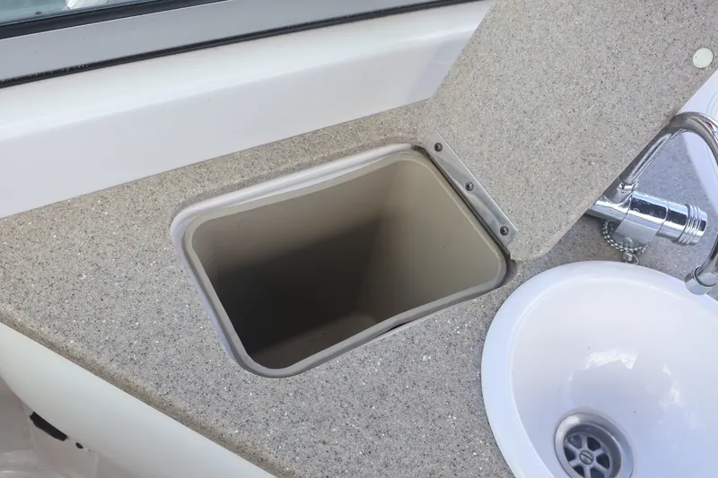 Slide: The Image of 2006 Four Winns H240 boat sink and countertop with open storage compartment. - 26