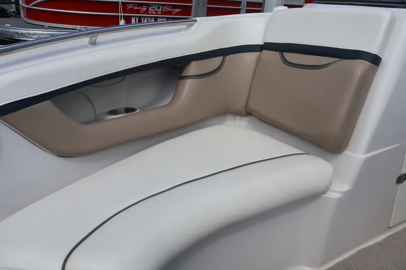 Slide: The Image of 2006 Four Winns H240 boat interior with beige and white seating. - 44