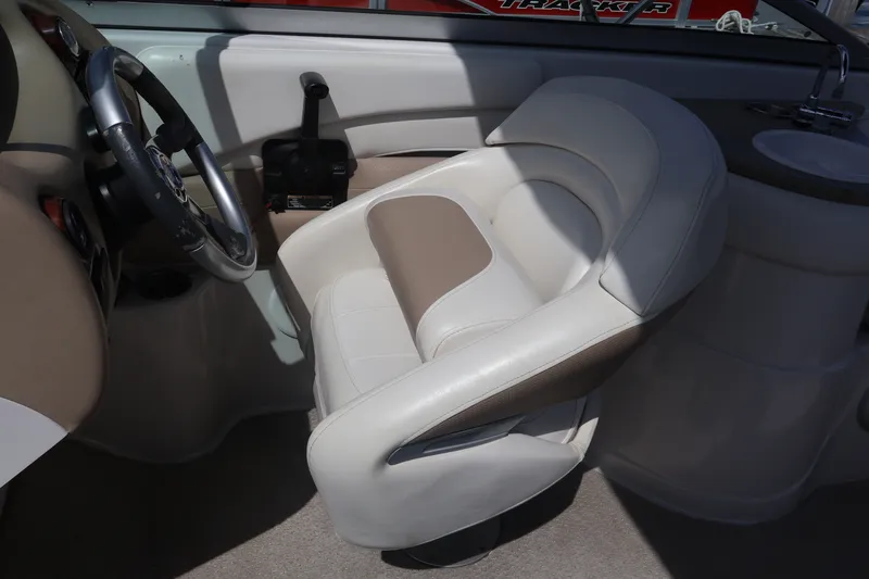 Slide: The Image of Captain's seat and steering wheel of 2006 Four Winns H240 boat interior. - 33