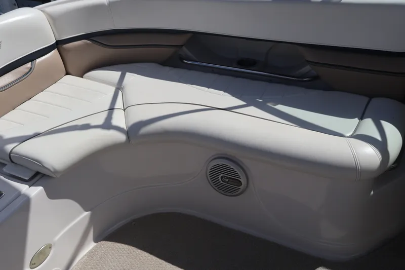 Slide: The Image of 2006 Four Winns H240 boat interior with cushioned seating and speaker. - 24
