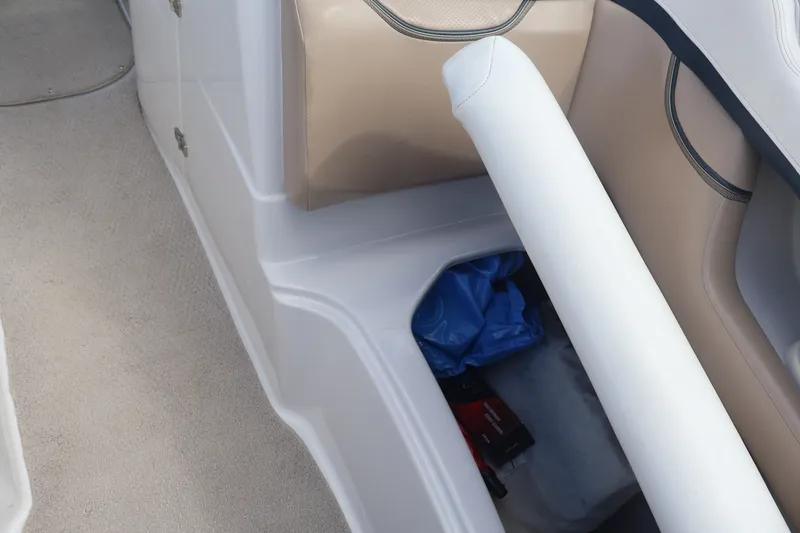 Slide: The Image of Interior storage compartment of 2006 Four Winns H240 boat with beige seating. - 43