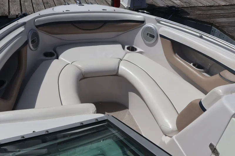 Slide: The Image of 2006 Four Winns H240 boat interior with white seating and cup holders. - 41