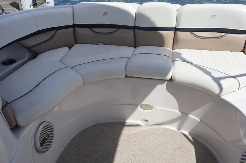 Slide: The Image of Luxurious seating area on a 2006 Four Winns H240 boat, featuring plush white upholstery. - 21