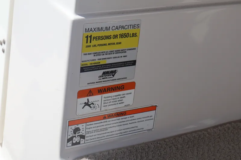 Slide: The Image of 2006 Four Winns H240 capacity and safety warning labels on boat interior. - 36