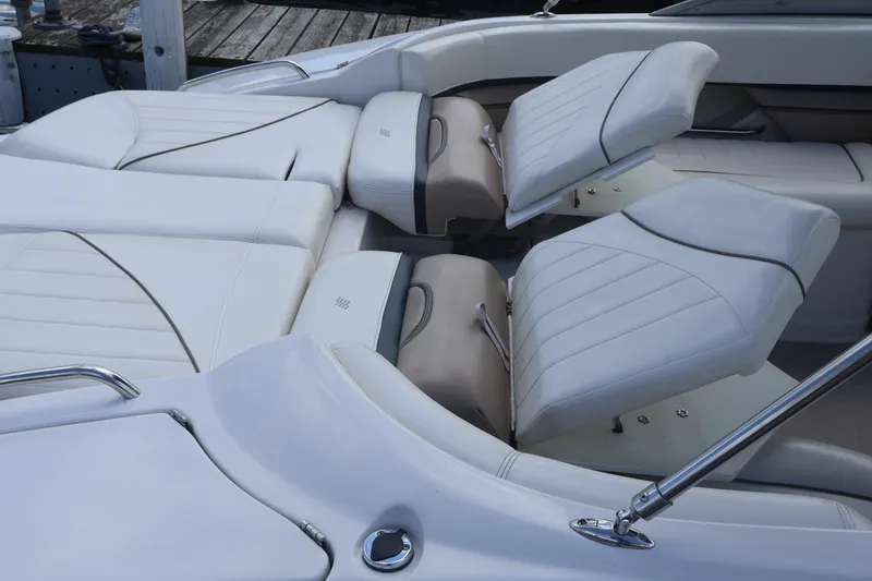 Slide: The Image of 2006 Four Winns H240 boat interior with adjustable white leather seating. - 17