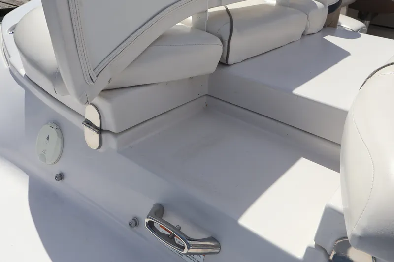 Slide: The Image of 2006 Four Winns H240 boat interior with white seating and stainless steel fixtures. - 19