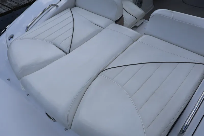 Slide: The Image of 2006 Four Winns H240 boat interior with white cushioned seating. - 13