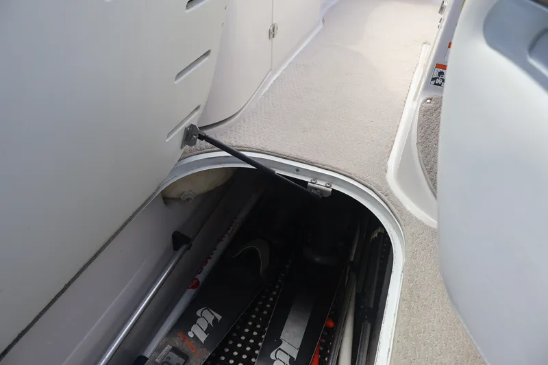 Slide: The Image of Storage compartment in a 2006 Four Winns H240 boat, showcasing interior space. - 47