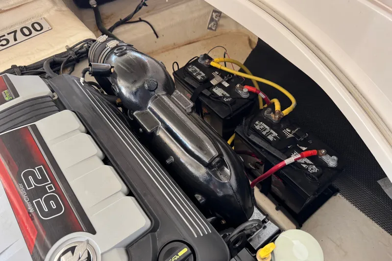 Slide: The Image of Engine compartment of 2019 Chaparral 264 Sunesta with batteries and wiring visible. - 14