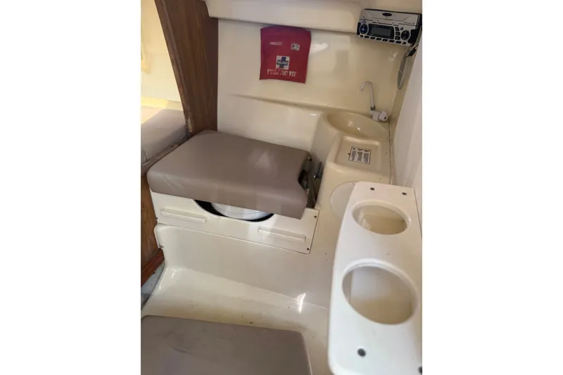 Slide: The Image of 2004 Scout 242 Abaco cabin interior with seating, storage, and radio equipment. - 17
