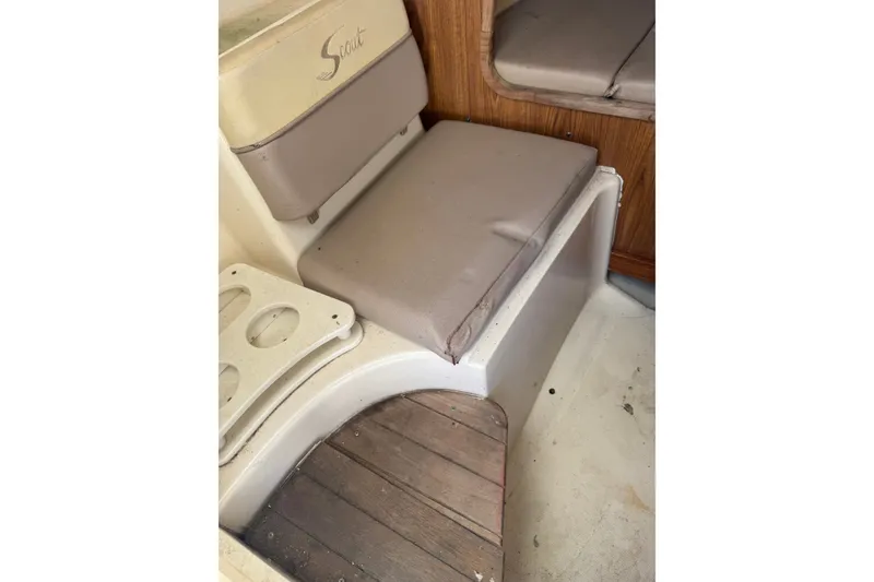 Slide: The Image of 2004 Scout 242 Abaco boat interior with cushioned seating and wooden flooring. - 15