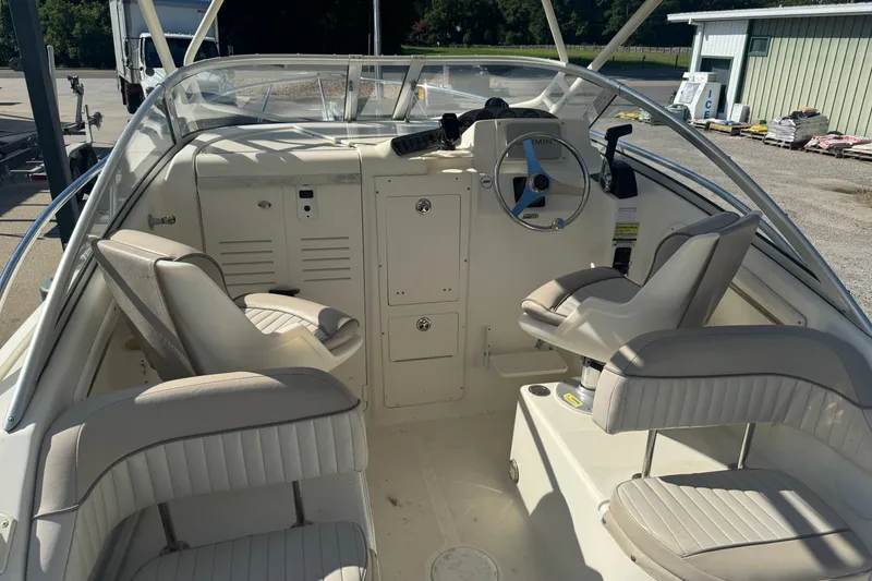 Slide: The Image of 2004 Scout 242 Abaco boat interior with steering wheel and seating arrangement. - 10