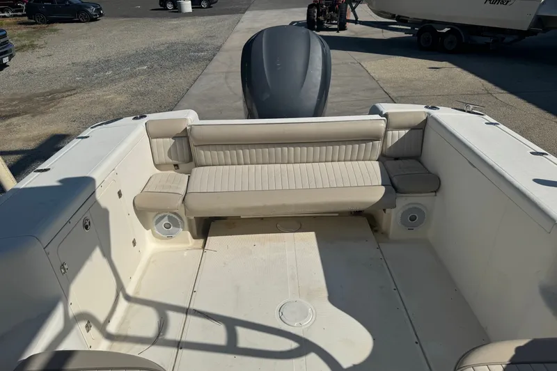 Slide: The Image of 2004 Scout 242 Abaco boat interior with beige seating and spacious deck. - 6