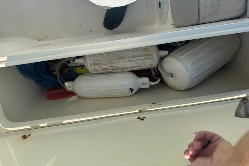 Slide: The Image of Storage compartment of a 2004 Scout 242 Abaco boat with fenders and ropes. - 9