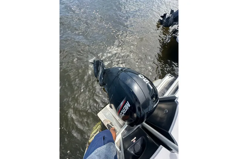 Slide: The Image of 2022 Bennington 22 SS boat with Mercury outboard motor on water. - 4