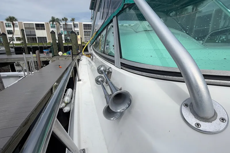 Slide: The Image of 1995 Cruisers Yachts 3570 Esprit docked, showcasing sleek design and chrome details. - 17