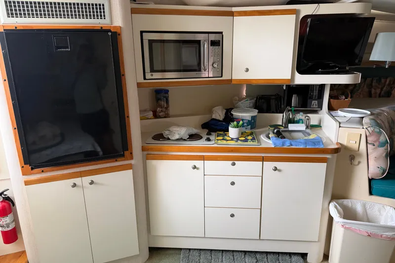 Slide: The Image of 1995 Cruisers Yachts 3570 Esprit interior kitchen with microwave, sink, and storage cabinets. - 41