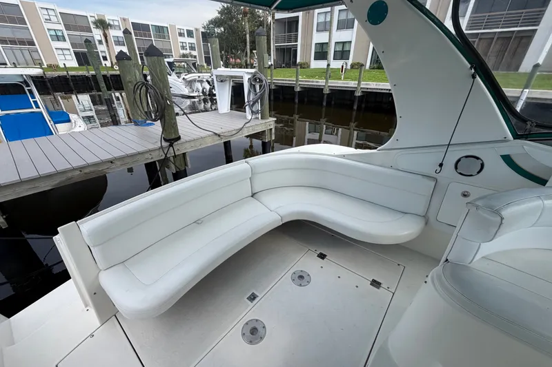 Slide: The Image of 1995 Cruisers Yachts 3570 Esprit interior with white seating at marina dock. - 22