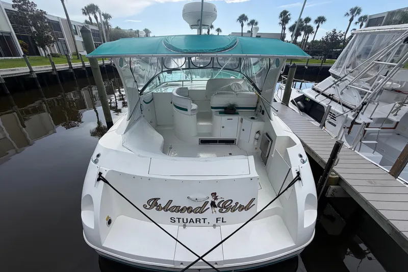 Slide: The Image of 1995 Cruisers Yachts 3570 Esprit docked, featuring "Island Girl" name, green canopy, and spacious deck. - 14