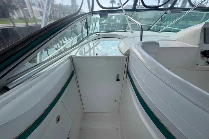 Slide: The Image of 1995 Cruisers Yachts 3570 Esprit interior with white seating and green accents. - 23