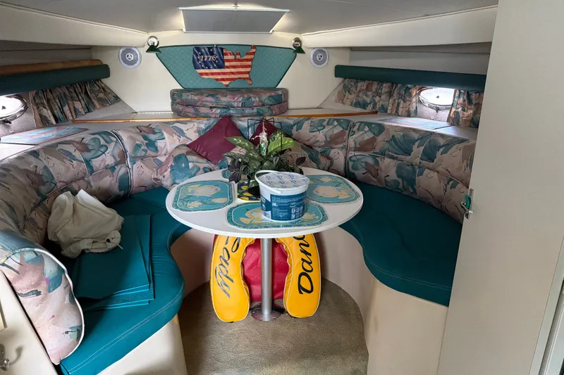 Slide: The Image of Interior of 1995 Cruisers Yachts 3570 Esprit with floral seating and decorative table. - 33