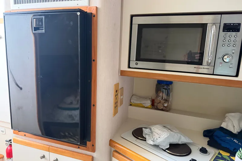 Slide: The Image of 1995 Cruisers Yachts 3570 Esprit kitchen with microwave, fridge, and stove. - 38