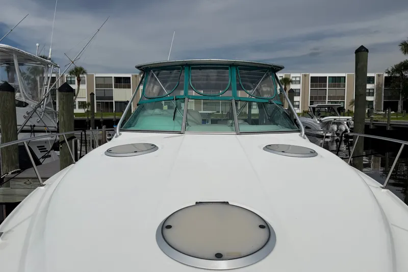 Slide: The Image of 1995 Cruisers Yachts 3570 Esprit docked, showcasing sleek design and spacious deck. - 18