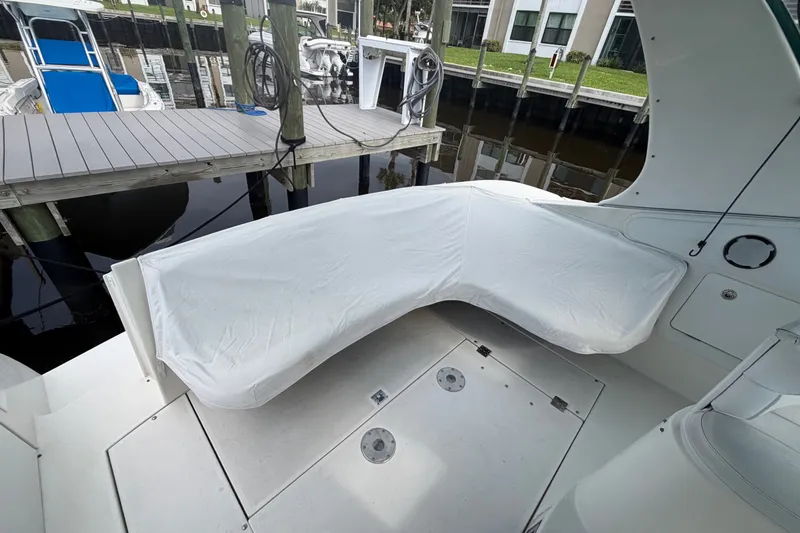 Slide: The Image of 1995 Cruisers Yachts 3570 Esprit boat interior with covered seating at dock. - 28