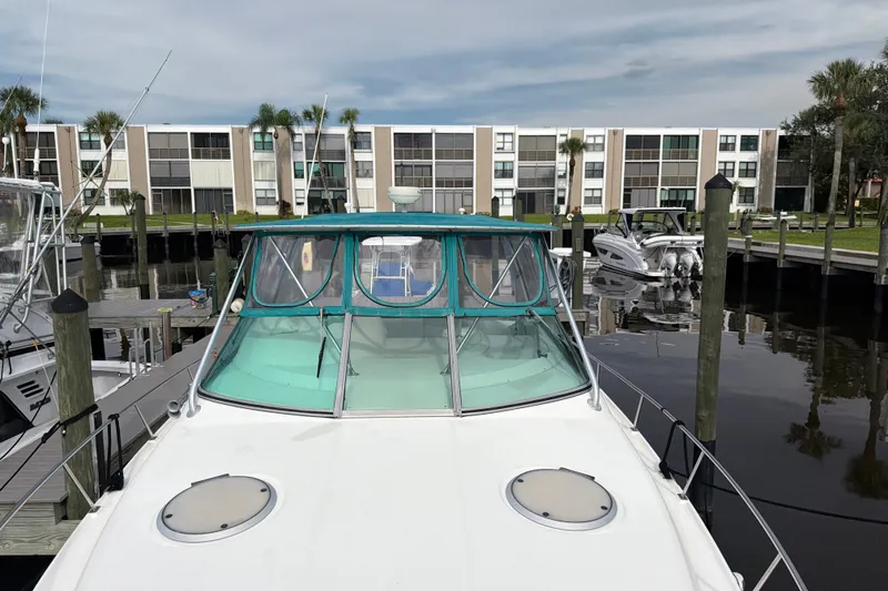 Slide: The Image of 1995 Cruisers Yachts 3570 Esprit docked at marina with waterfront apartments. - 20