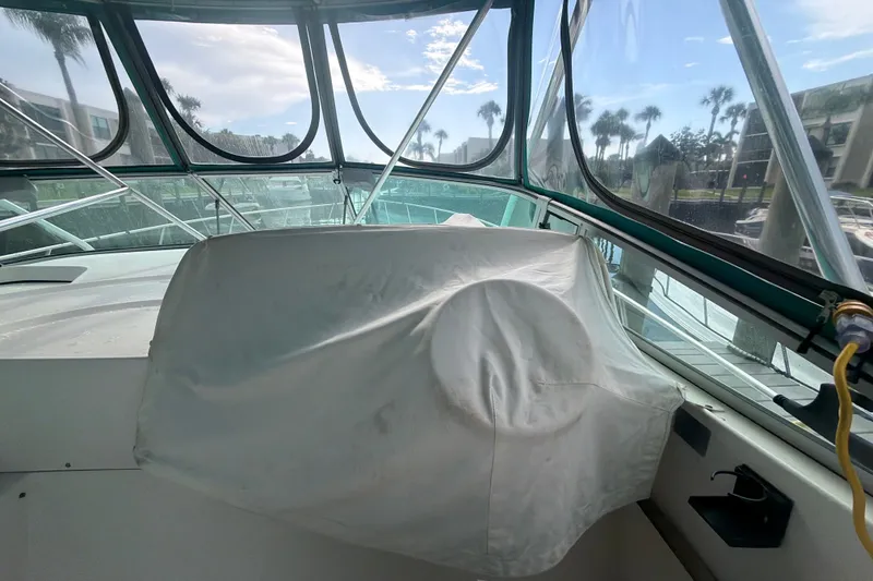 Slide: The Image of 1995 Cruisers Yachts 3570 Esprit helm covered, with marina view through windows. - 30
