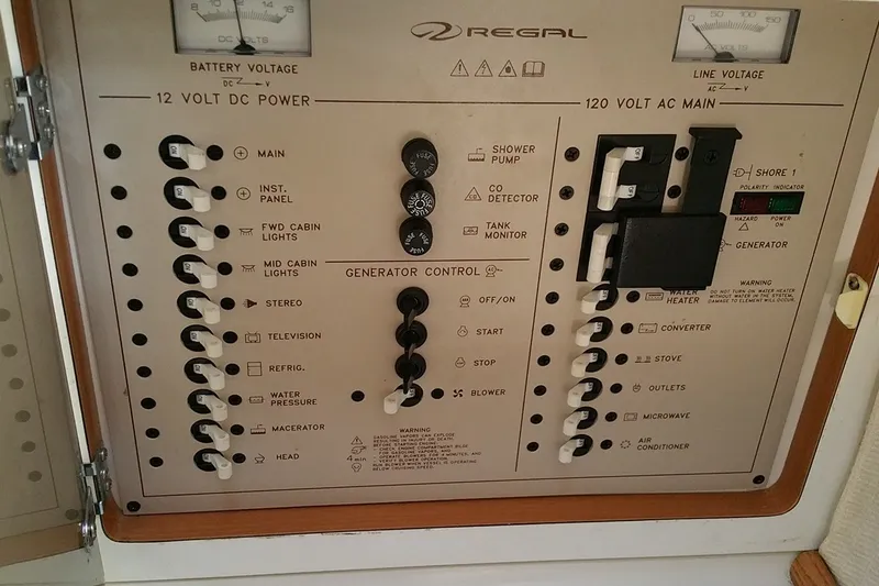 Slide: The Image of Electrical control panel of a 2001 Regal Commodore 2760 boat, showing switches and gauges. - 20