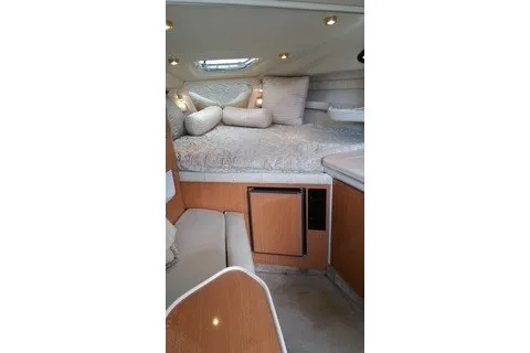 Slide: The Image of 2001 Regal Commodore 2760 cabin interior with cozy bed and seating area. - 16