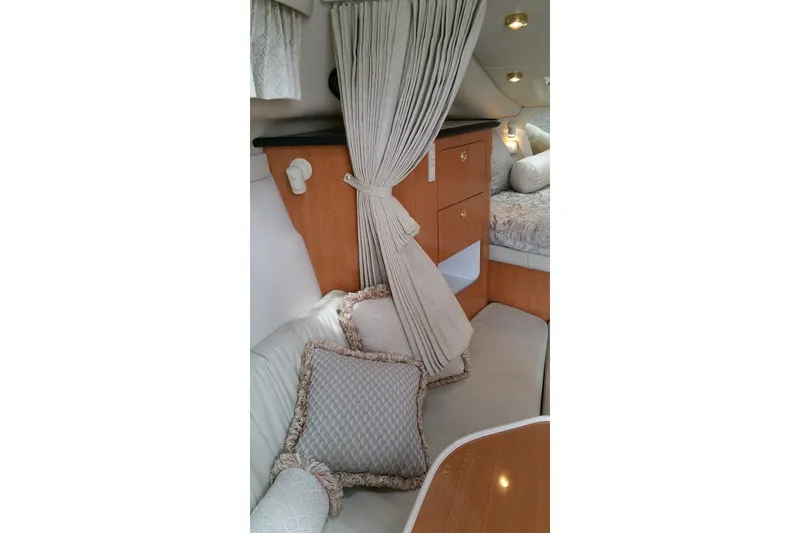 Slide: The Image of Interior of 2001 Regal Commodore 2760 boat with cozy seating and elegant decor. - 18