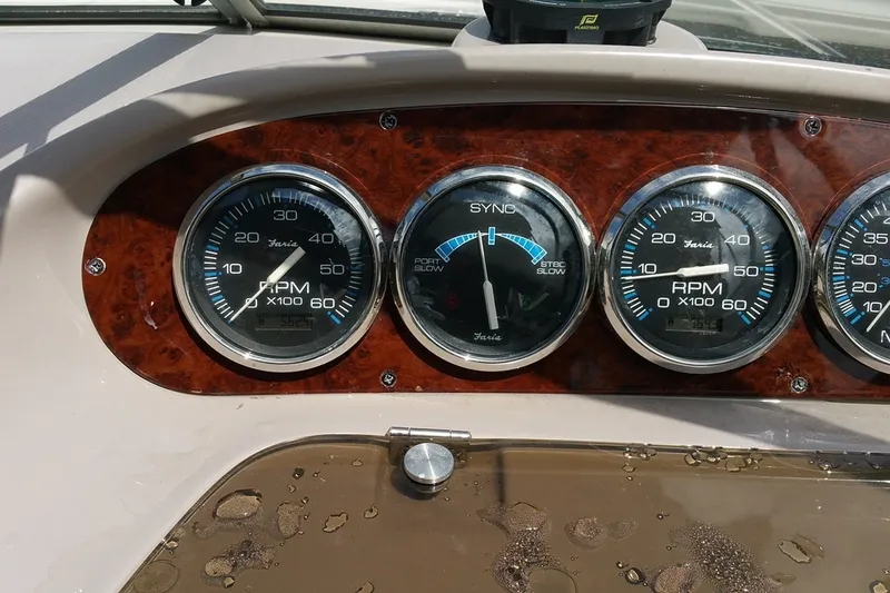 Slide: The Image of Dashboard of a 2001 Regal Commodore 2760 boat with RPM gauges. - 14