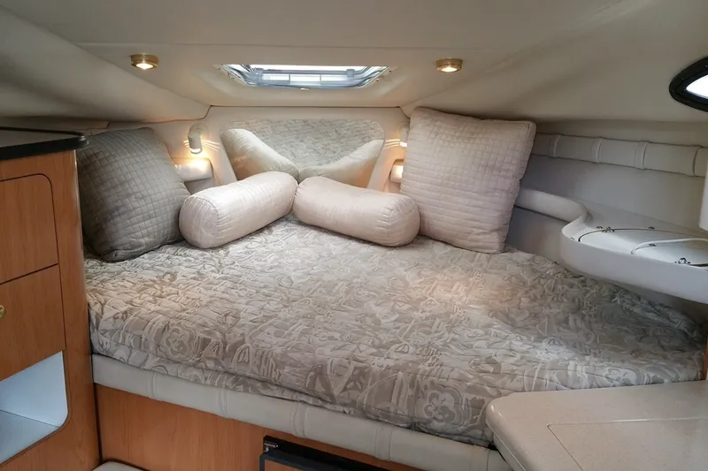Slide: The Image of Cozy cabin interior of 2001 Regal Commodore 2760 with plush bedding and pillows. - 17