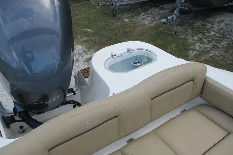 Slide: The Image of 2020 NauticStar 2302 Legacy Dual Console boat with Yamaha engine and beige seating. - 13