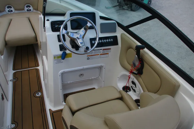 Slide: The Image of 2020 NauticStar 2302 Legacy Dual Console boat interior with steering wheel and seating. - 17