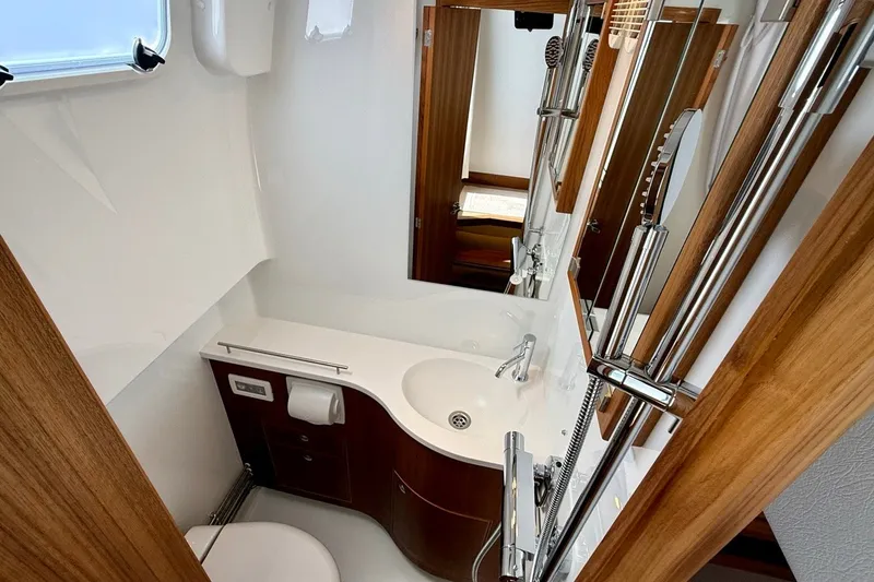 Slide: The Image of Modern bathroom interior in 2027 Targa 32 boat, featuring sleek fixtures and wood accents. - 22
