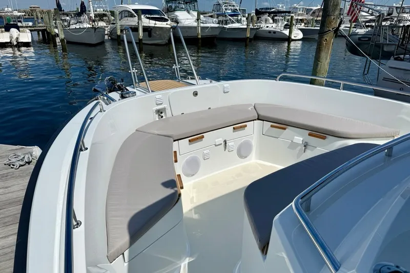 Slide: The Image of Bow seating area of a 2027 Targa 32 boat docked at a marina. - 13